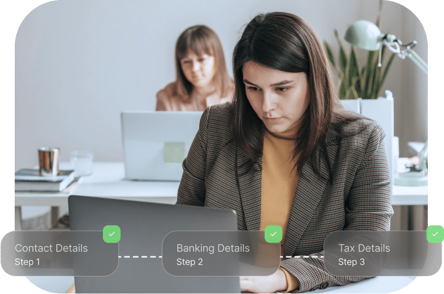 Two people working at laptops in an office. A progress tracker on the image shows steps: Contact Details, Banking Details, and Tax Details, all completed.