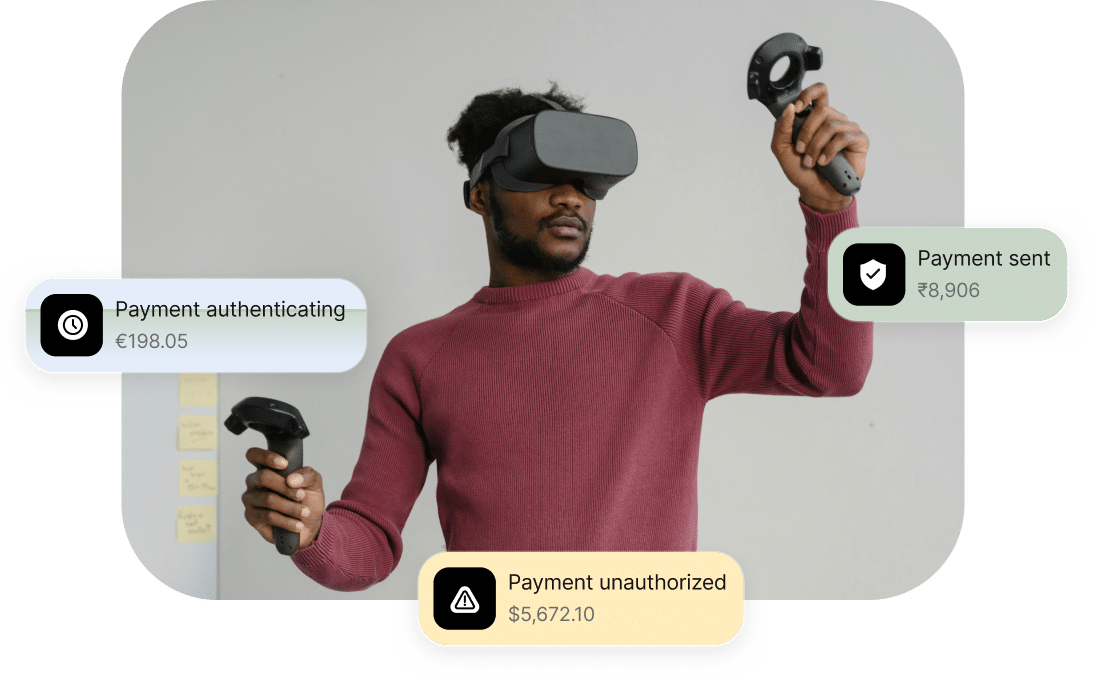A person wearing a VR headset and holding controllers, with three notifications around them: "Payment authenticating €198.05," "Payment sent ₹8,906," and "Payment unauthorized $5,672.10.