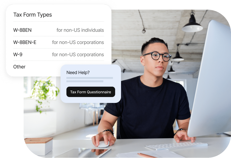 A person seated at a desk using a computer. A pop-up on the screen shows tax form types including W-8BEN, W-8BEN-E, and W-9. A help box offers a "Tax Form Questionnaire" button.