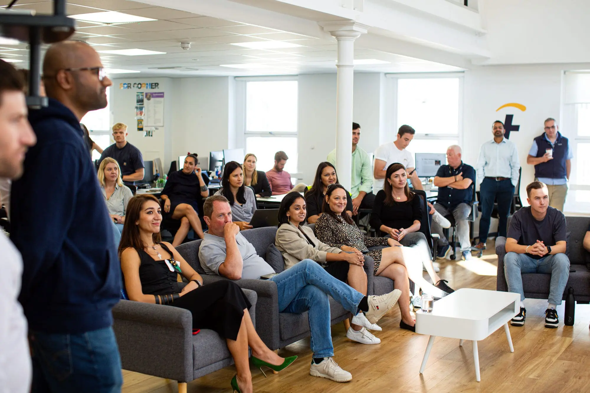 A group of people sitting in a conference room.